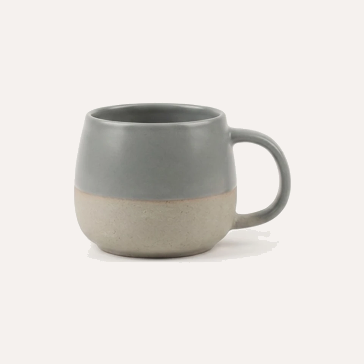 Grey glazed mug with a band of unglazed clay left bare around the foot, showing the matt, slightly rough raw body beneath the glaze