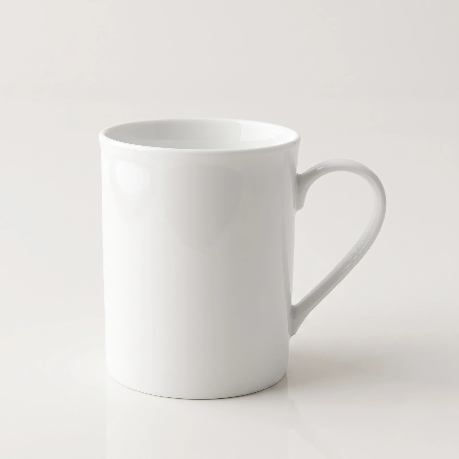 Straight-sided white porcelain mug with a slim pulled handle
