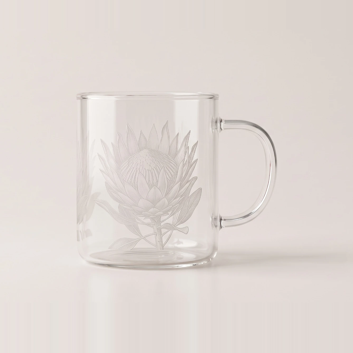 Clear glass mug with a protea etched into the surface in fine frosted line work