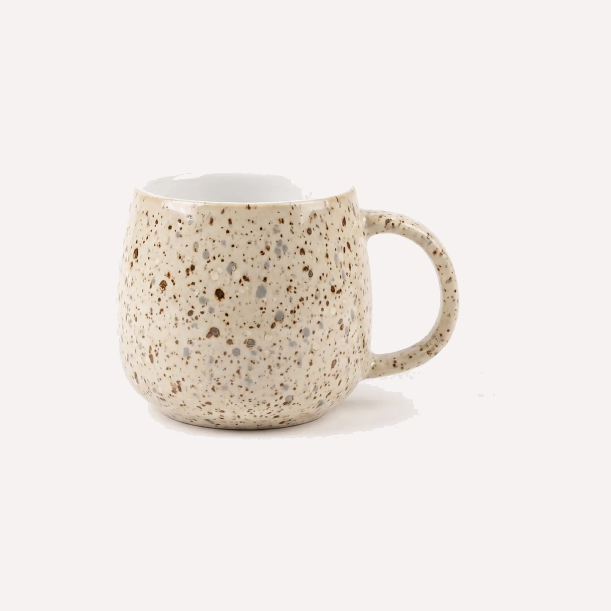 Cream glazed mug scattered with fine brown and grey specks that come through the glaze, giving a lightly textured, stone-like surface