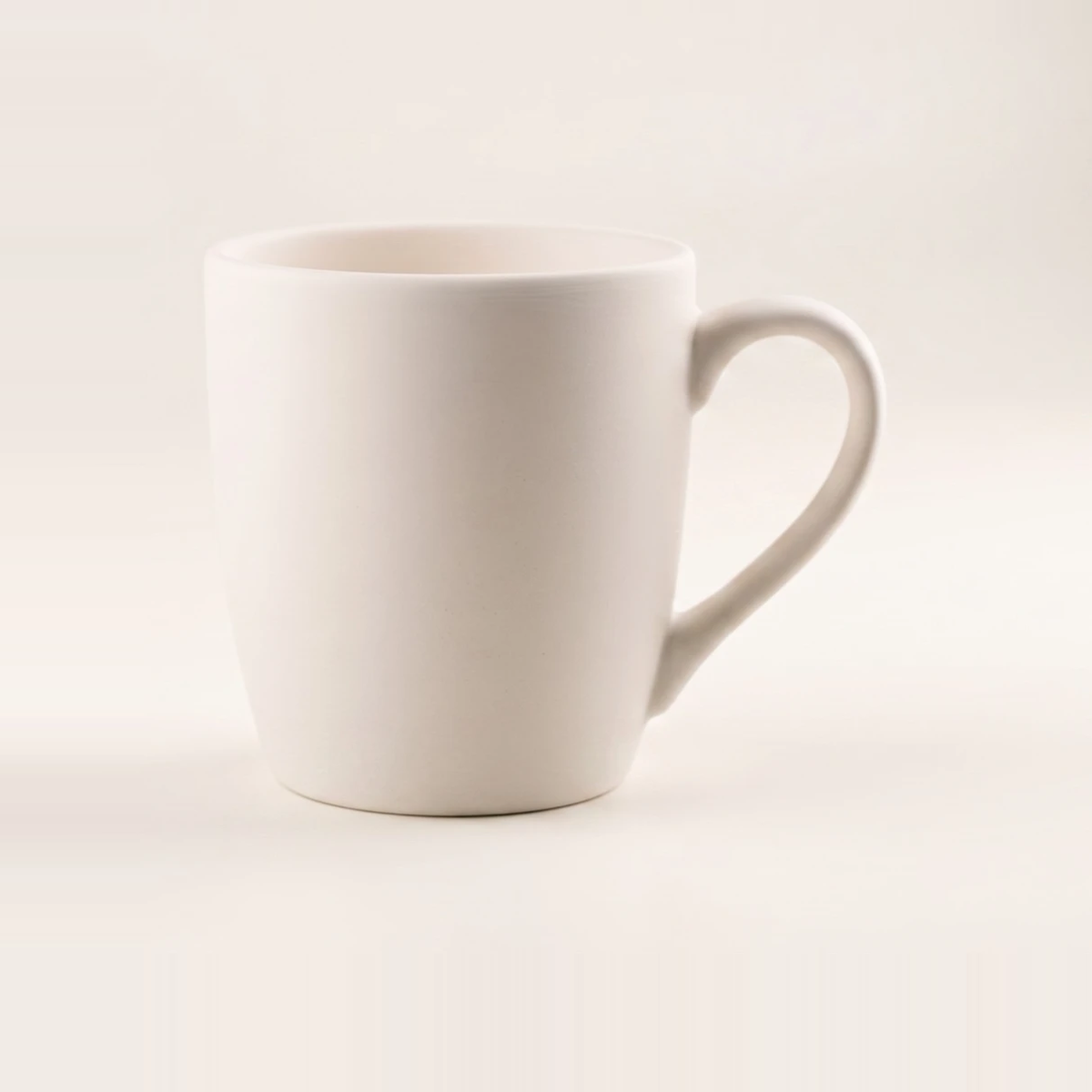 Tapered new bone china mug with a soft matt white finish and a fine curved handle