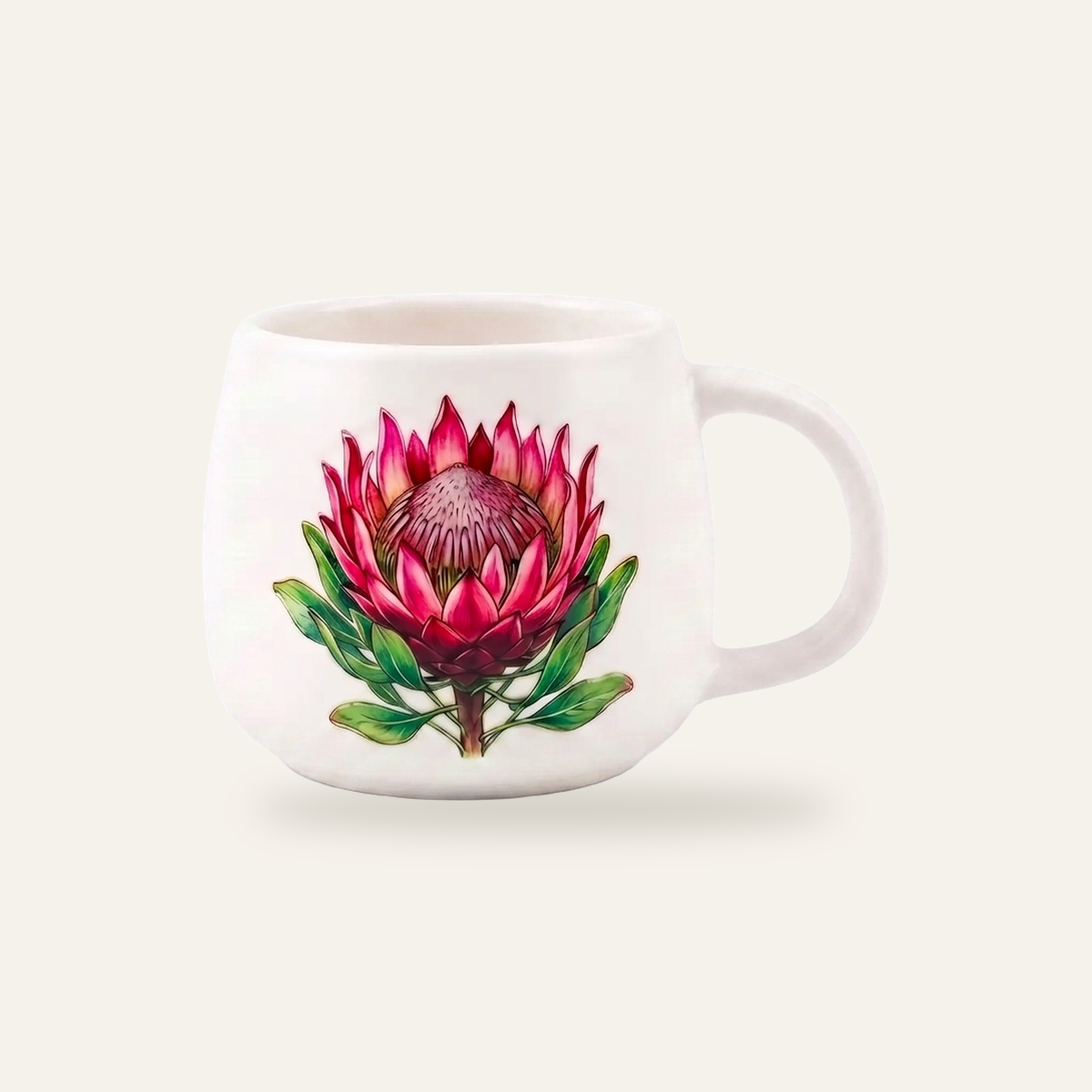 White glazed mug photographed straight on, with a full colour protea decal sitting on top of the glaze, the print sharp edged, saturated and slightly proud of the surface