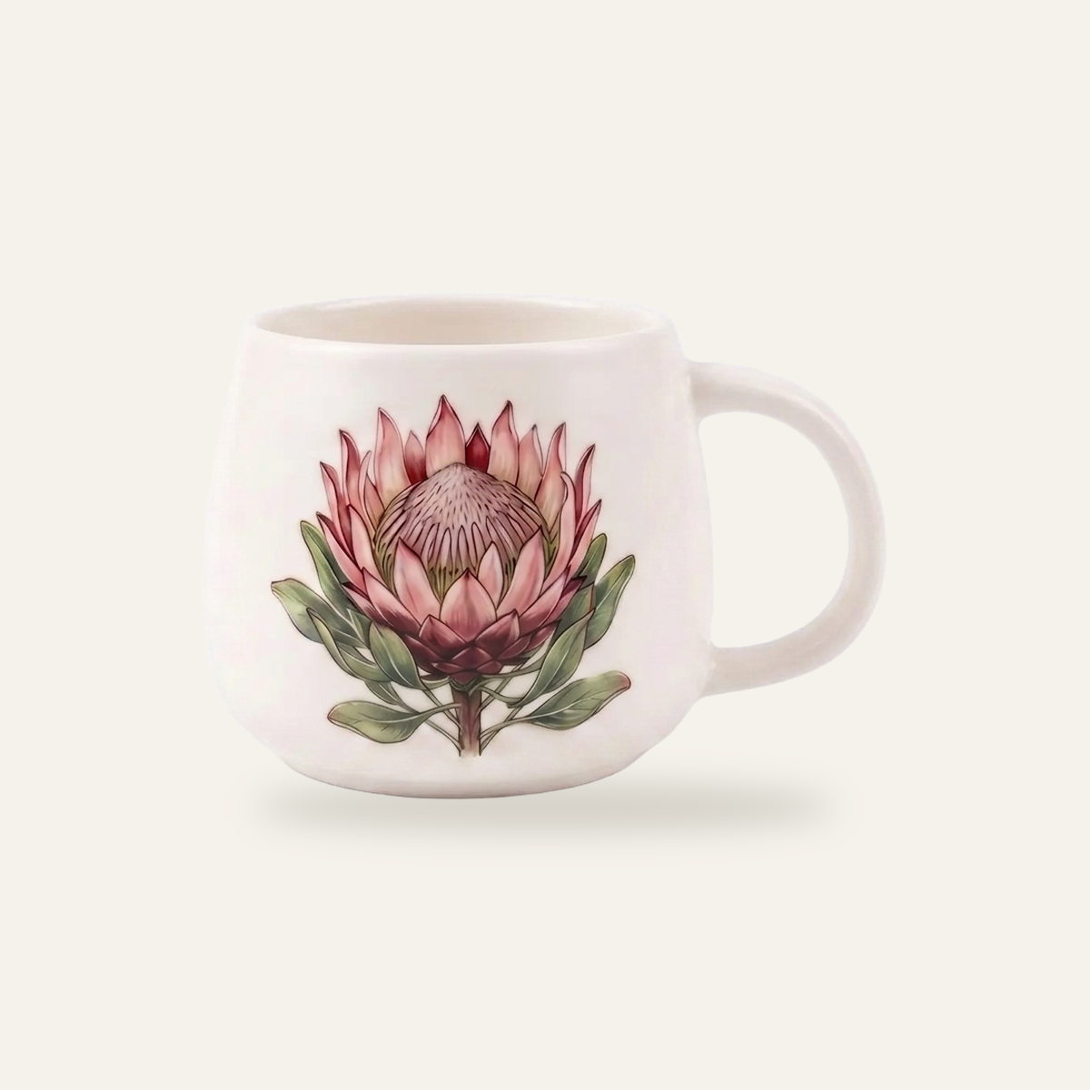 White glazed mug photographed straight on, with a protea decal fired into the glaze so the colour sits flush and slightly muted under a continuous glossy surface